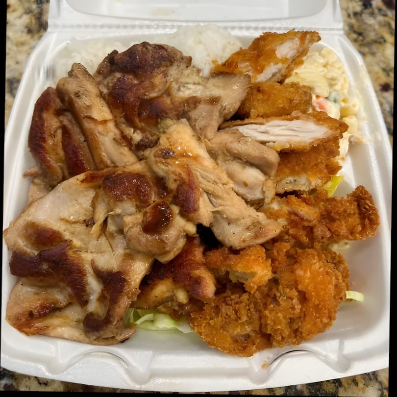 A Hawaiian BBQ plate with grilled chicken, crispy fried chicken, rice, and macaroni salad.