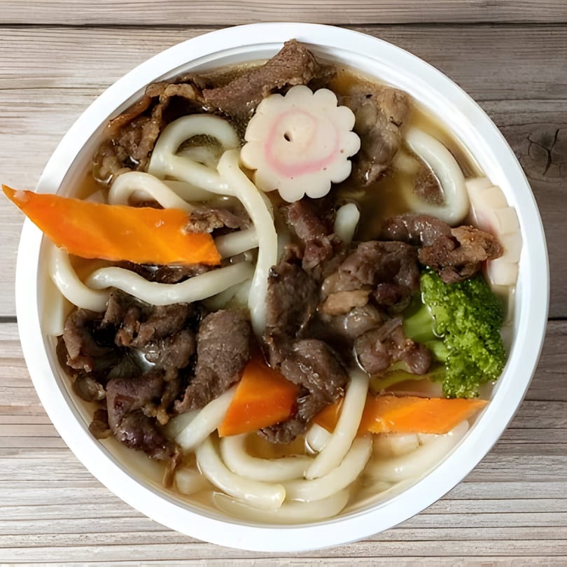 Young Hawaiian BBQ's beef udon soup with carrots, broccoli, and a fish cake.